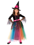 Girl wearing a Spider Witch dress with rainbow tulle skirt, glitter web bodice and pink-banded witch hat with spider
