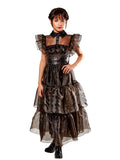 Girl wearing a Wednesday Rave'N black dress with puffed tulle shoulders, mesh chest panel, belt and tiered skirt