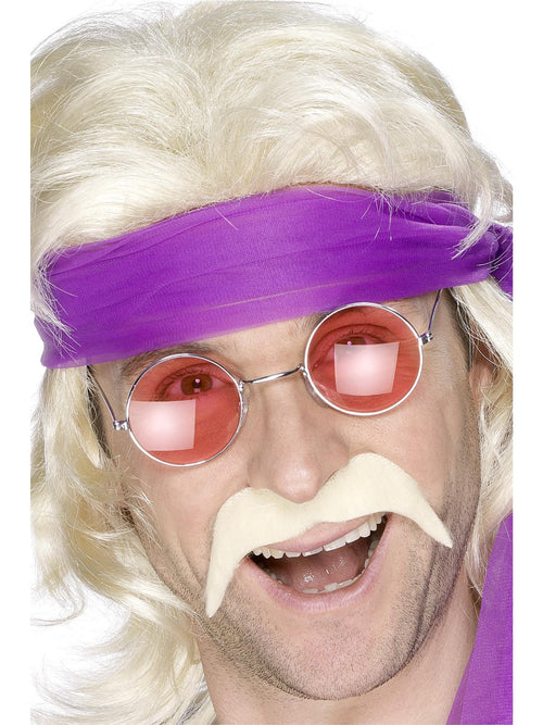 Man wearing a blonde 70s horseshoe moustache with round tinted glasses and headband