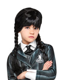 Girl wearing the black plaited Wednesday wig with a thick fringe