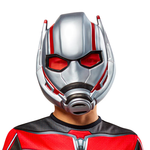 Child wearing a silver and red Ant-Man Quantumania mask with red ant-shaped eyes