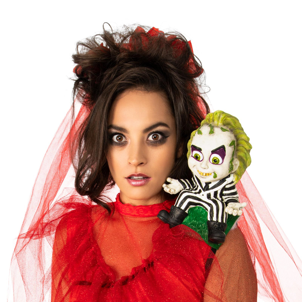 Woman in a red veil with a moulded Beetlejuice figure sitting on her shoulder
