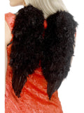 Woman wearing small black feather angel wings, back view