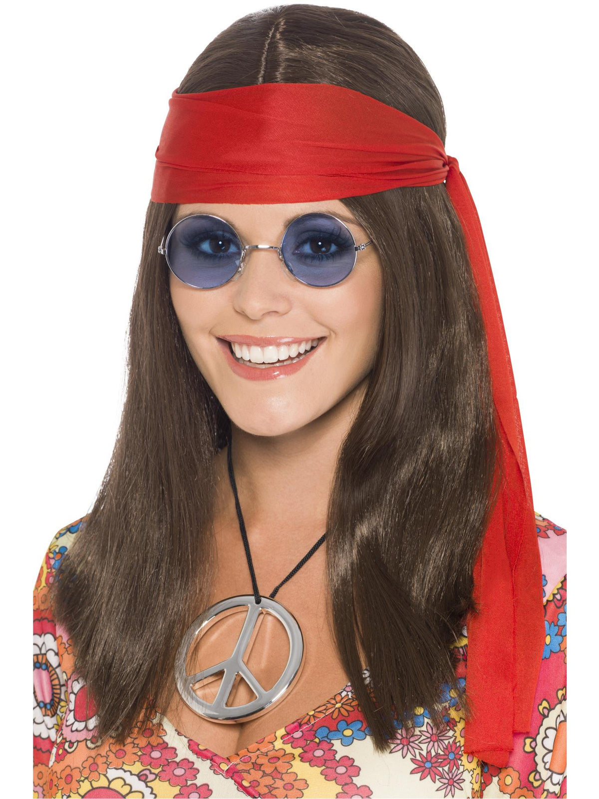 Woman wearing a long brown hippie wig, red headscarf, blue round glasses and peace sign medallion