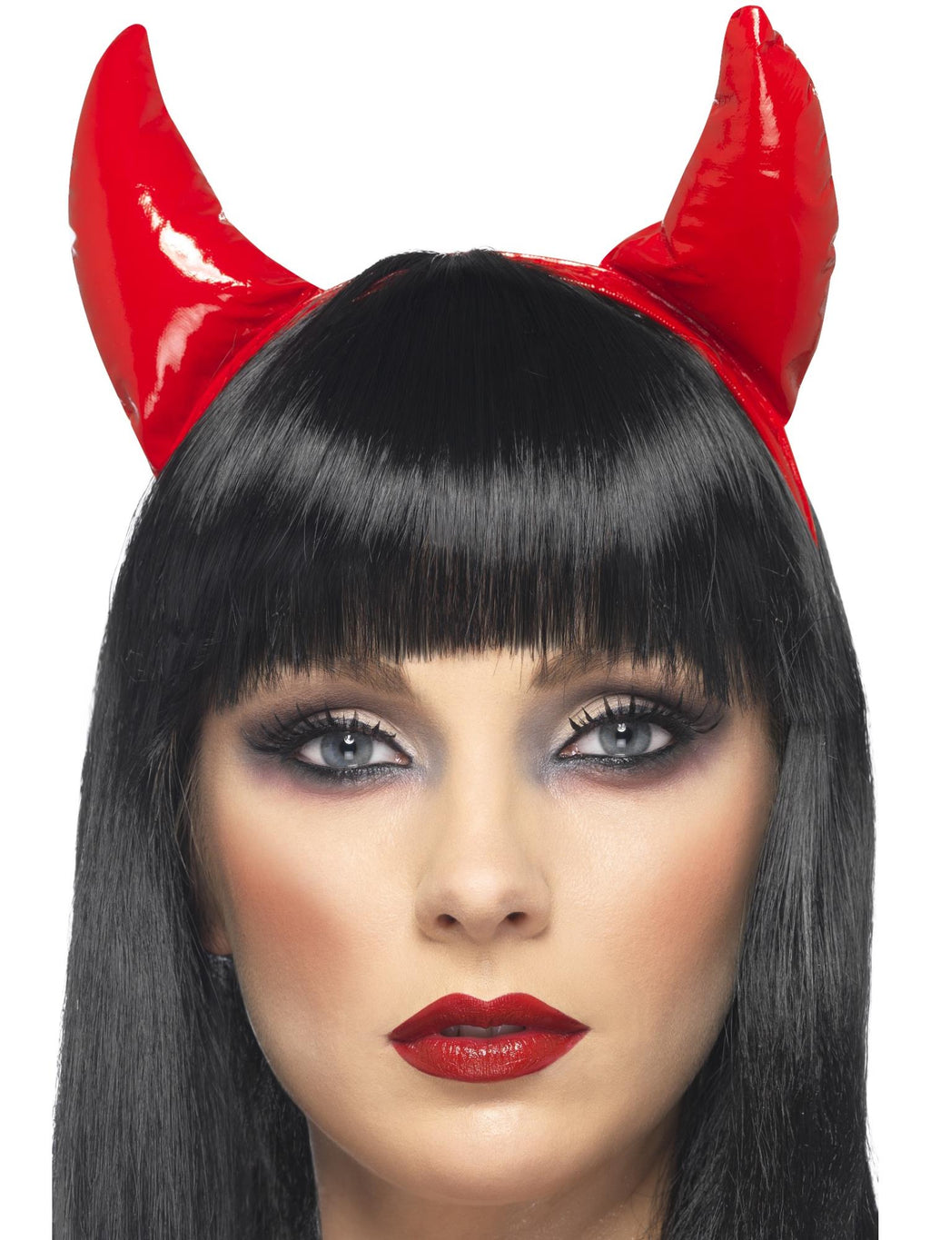 Woman wearing shiny red devil horns on a headband
