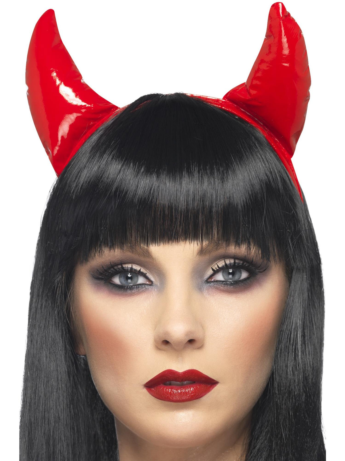 Woman wearing shiny red devil horns on a headband