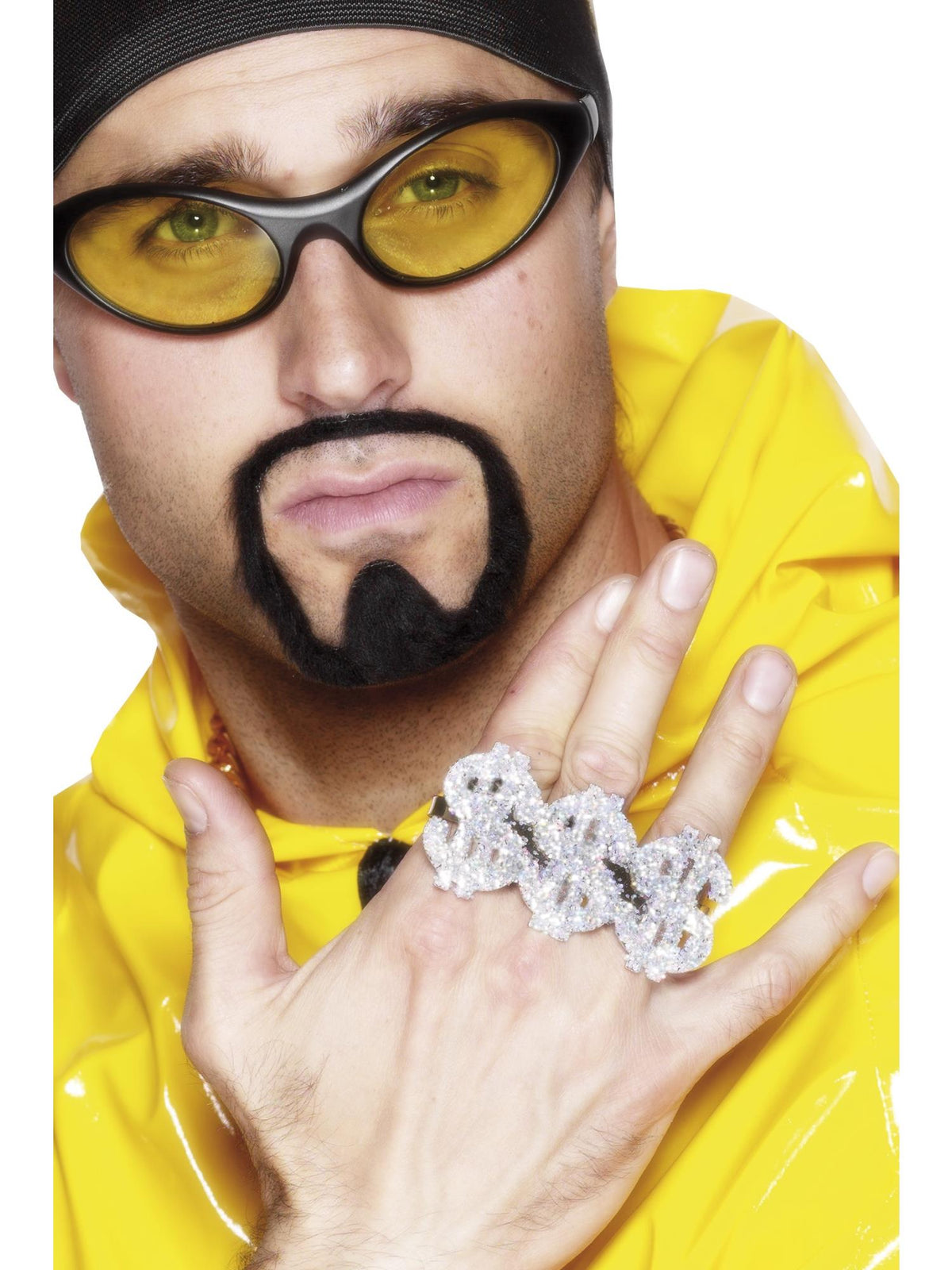 Hand wearing a large silver diamante dollar sign ring across three fingers