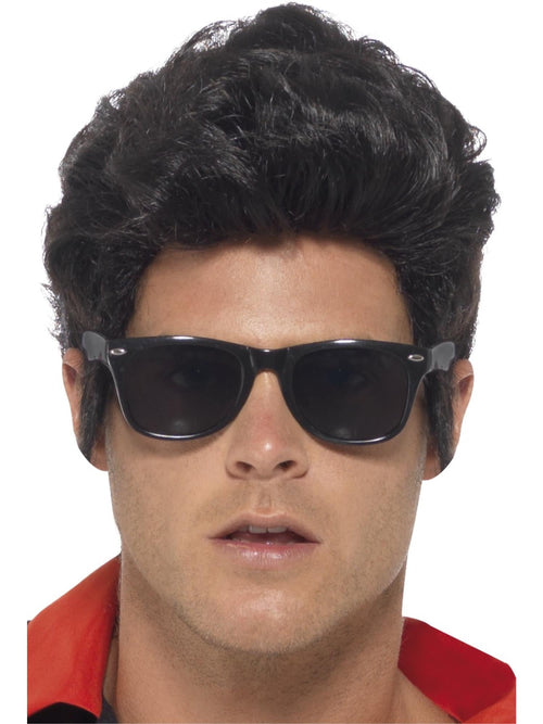 Man wearing black 50s style specs with dark lenses