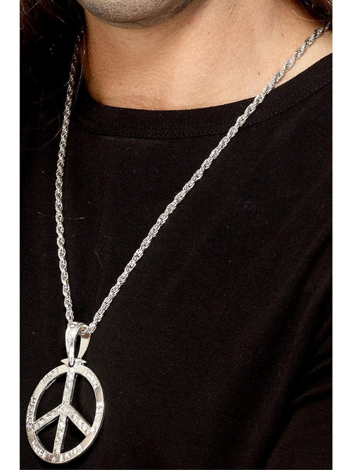 Silver peace sign medallion on a silver chain worn over a black top