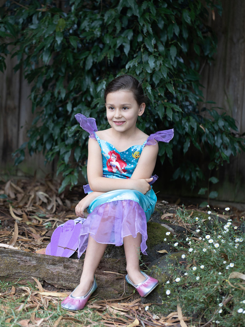 Girl in Ariel dress with printed bodice, purple tulle sleevelets and purple tulle mermaid tail