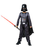 Boy in Darth Vader costume with printed jumpsuit, cape, helmet mask and red toy lightsaber