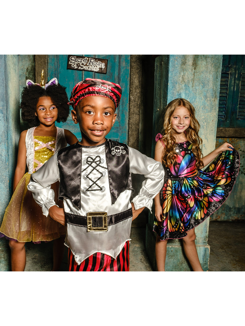 Girl in the rainbow butterfly dress alongside two other children in costumes