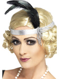 Woman wearing a silver Charleston headband with a black feather and jewelled brooch