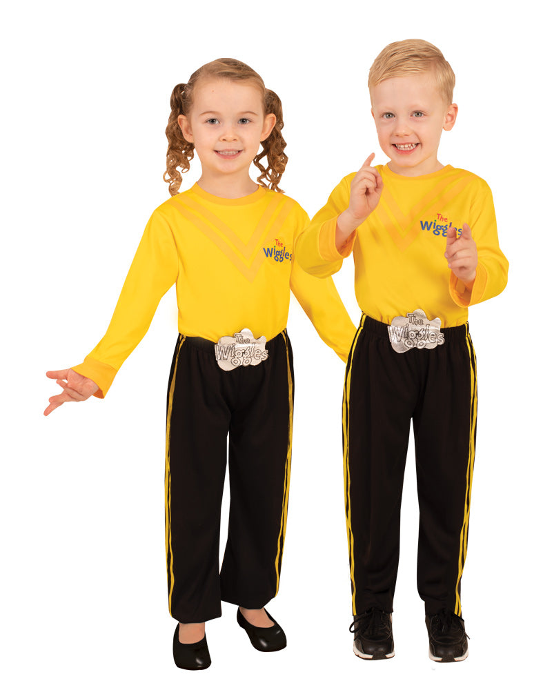 Two children in yellow Wiggles tops with printed V stripes and logo, black pants with yellow stripes and belt buckle