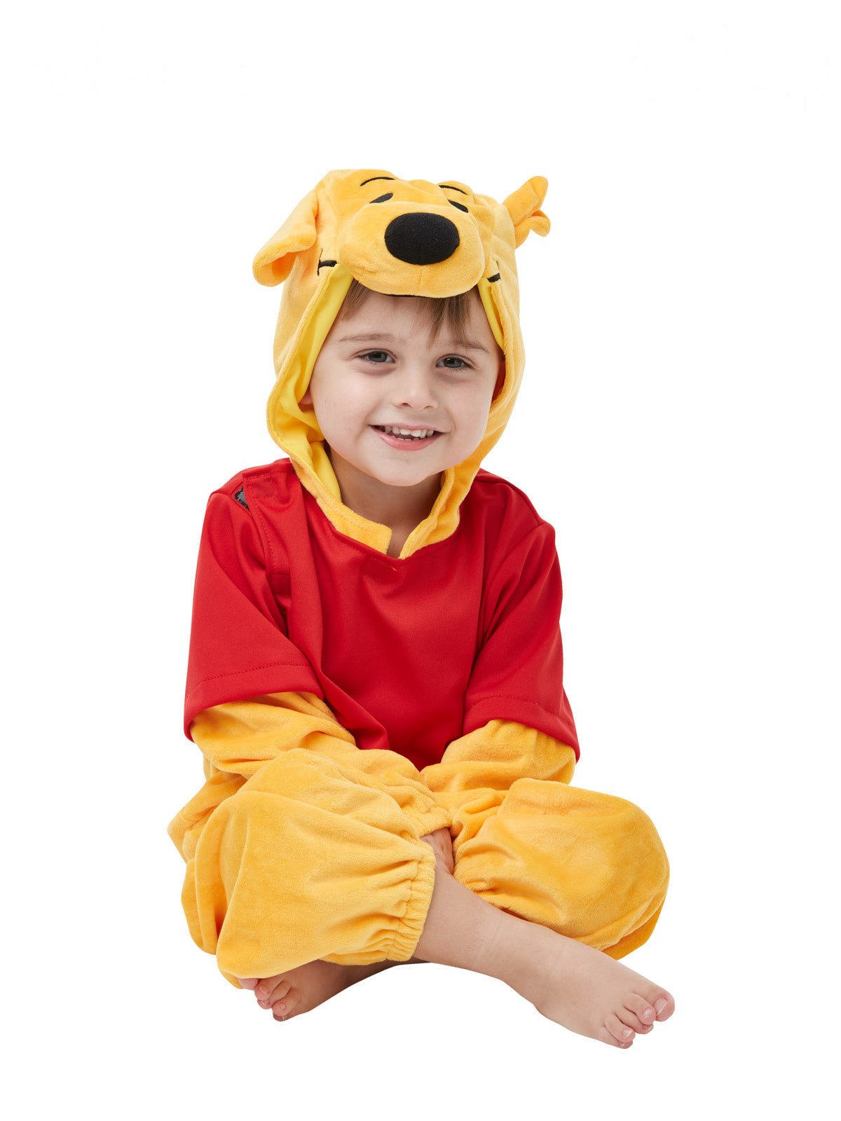Toddler in the Winnie The Pooh Deluxe costume, a plush yellow jumpsuit with red top and character hood