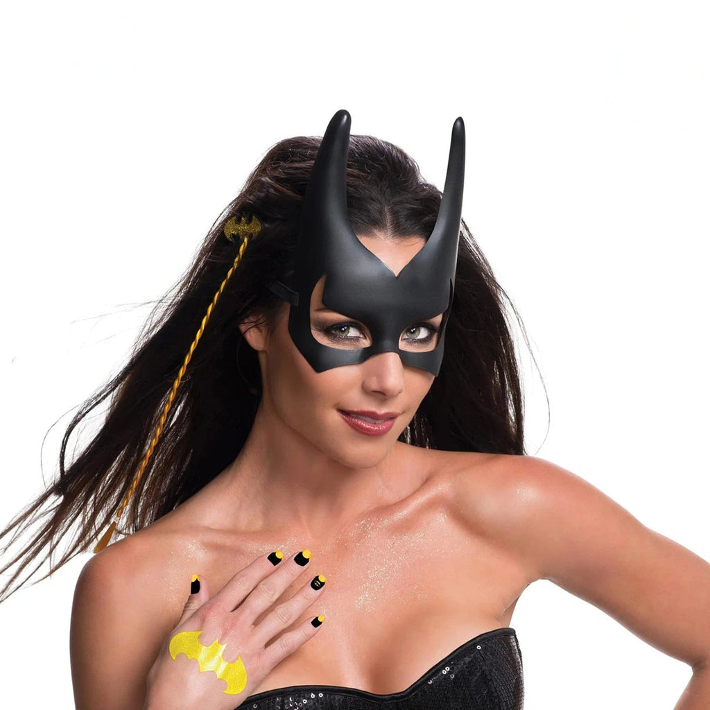 Woman styled as Batgirl with a two-tone hair extension, black nail decals and a yellow bat tattoo on her hand