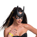 Woman styled as Batgirl with a two-tone hair extension, black nail decals and a yellow bat tattoo on her hand