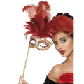 Woman holding a gold baroque eyemask on a stick with tall red feathers