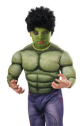 Boy in a Hulk costume wearing the short black messy Hulk wig