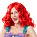 Woman wearing the long wavy bright red Ariel wig