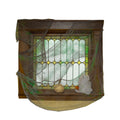 Sheer grey and green gauze drape hung over a window frame