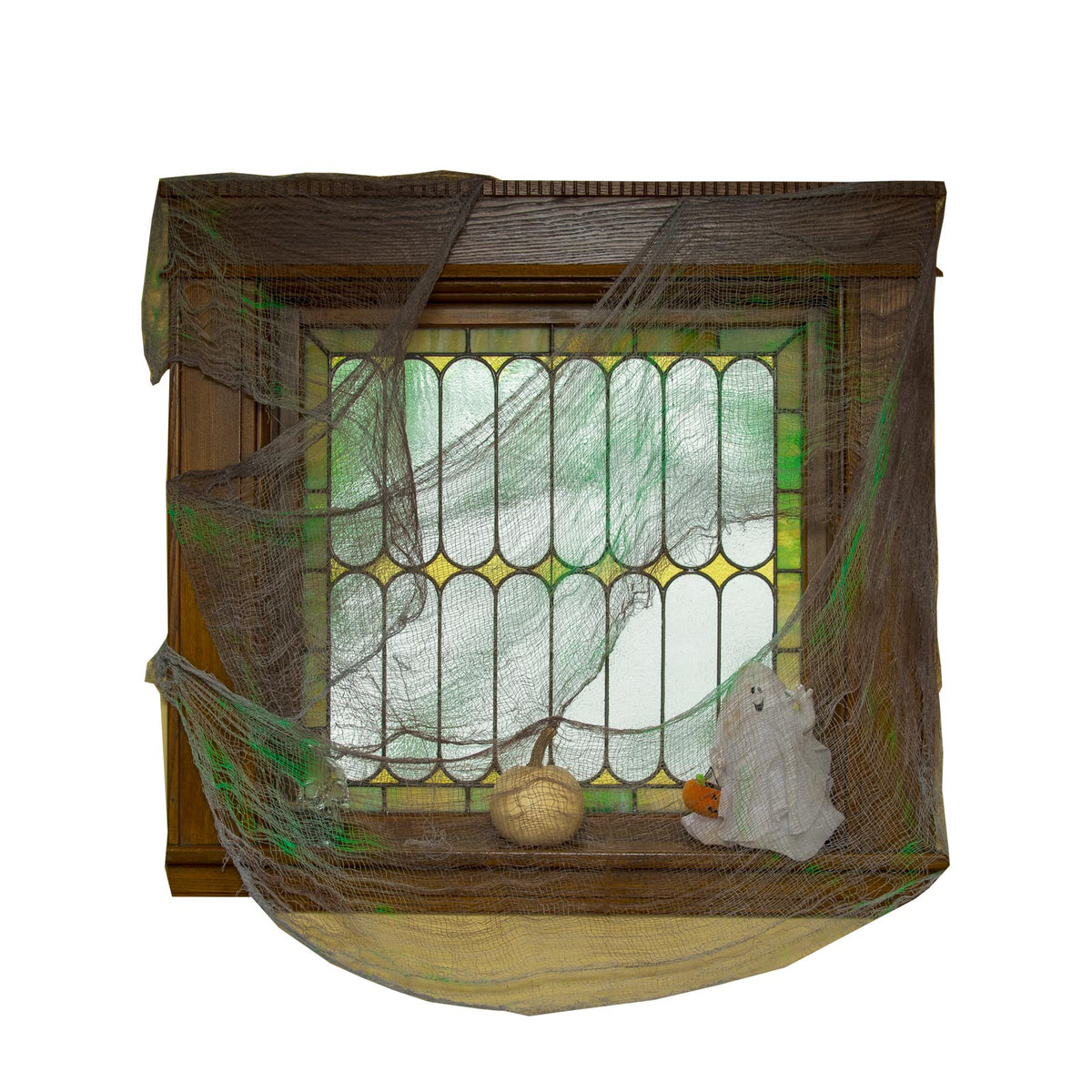 Sheer grey and green gauze drape hung over a window frame