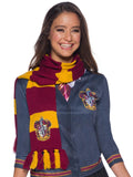 Woman wearing a red and gold striped Gryffindor scarf with embroidered crest and tasselled ends