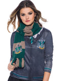 Woman wearing a green and grey striped Slytherin knit scarf with house emblem