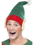 Man wearing a green elf hat with red band, white pom pom and attached pointed elf ears