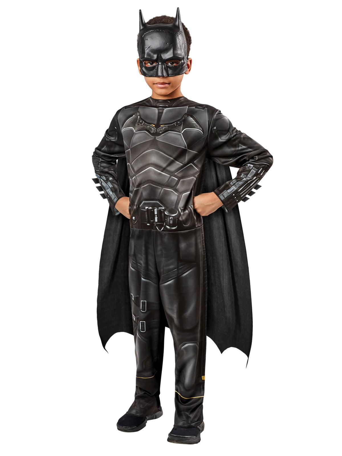 Boy in The Batman classic costume, a black armour-print jumpsuit with bat logo, cape and cowl mask