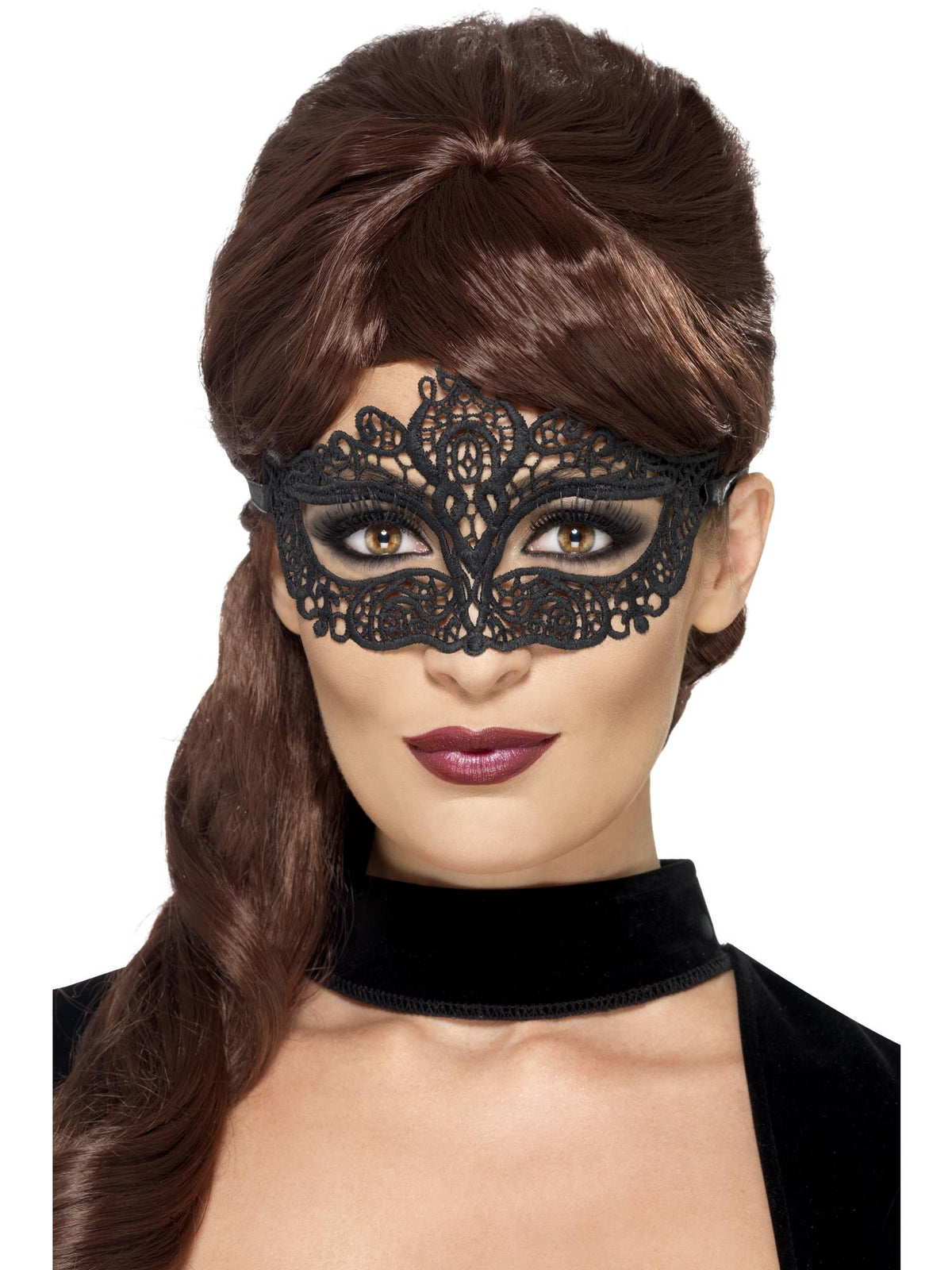 Woman wearing a black filigree lace eyemask with embellished swirls