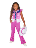 Girl in hot pink Barbie cowgirl jumpsuit with tassels and star print, holding white cowgirl hat