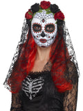 Woman wearing a Day of the Dead sugar skull mask with red and black roses and a black lace veil