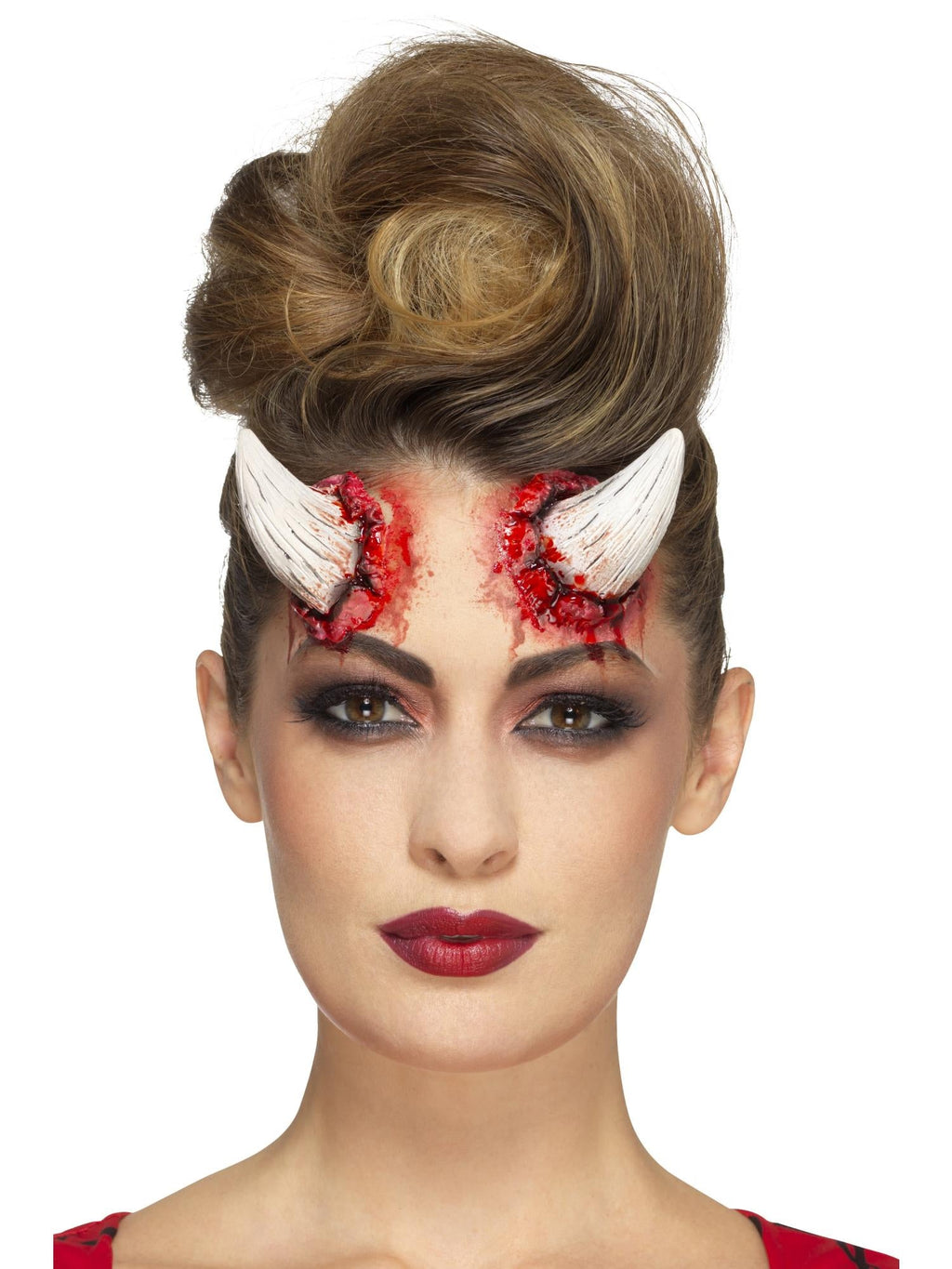Woman wearing cream latex devil horn prosthetics on her forehead