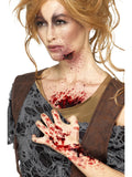 Woman with dark red scab blood effects on her face, chest and hand