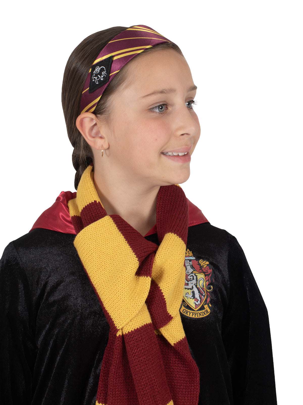 Girl wearing the striped Gryffindor headband and maroon and gold knit scarf