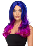 Woman wearing a long wavy blue to pink ombre wig