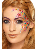 Woman wearing rainbow jewel face gems arranged around one eye