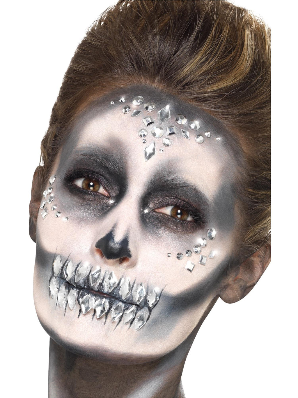 Woman with skull face paint decorated with silver jewel face gems