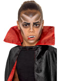 Child with vampire face paint and fake fangs created with the kit