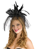 Woman wearing a mini black witch hat headband with veil and feathers