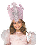 Girl wearing the tall pink Glinda crown with silver jewels