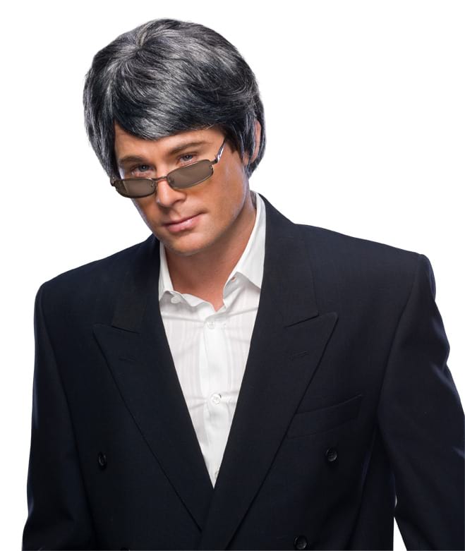 Man in a suit wearing a short black and grey streaky wig with side part