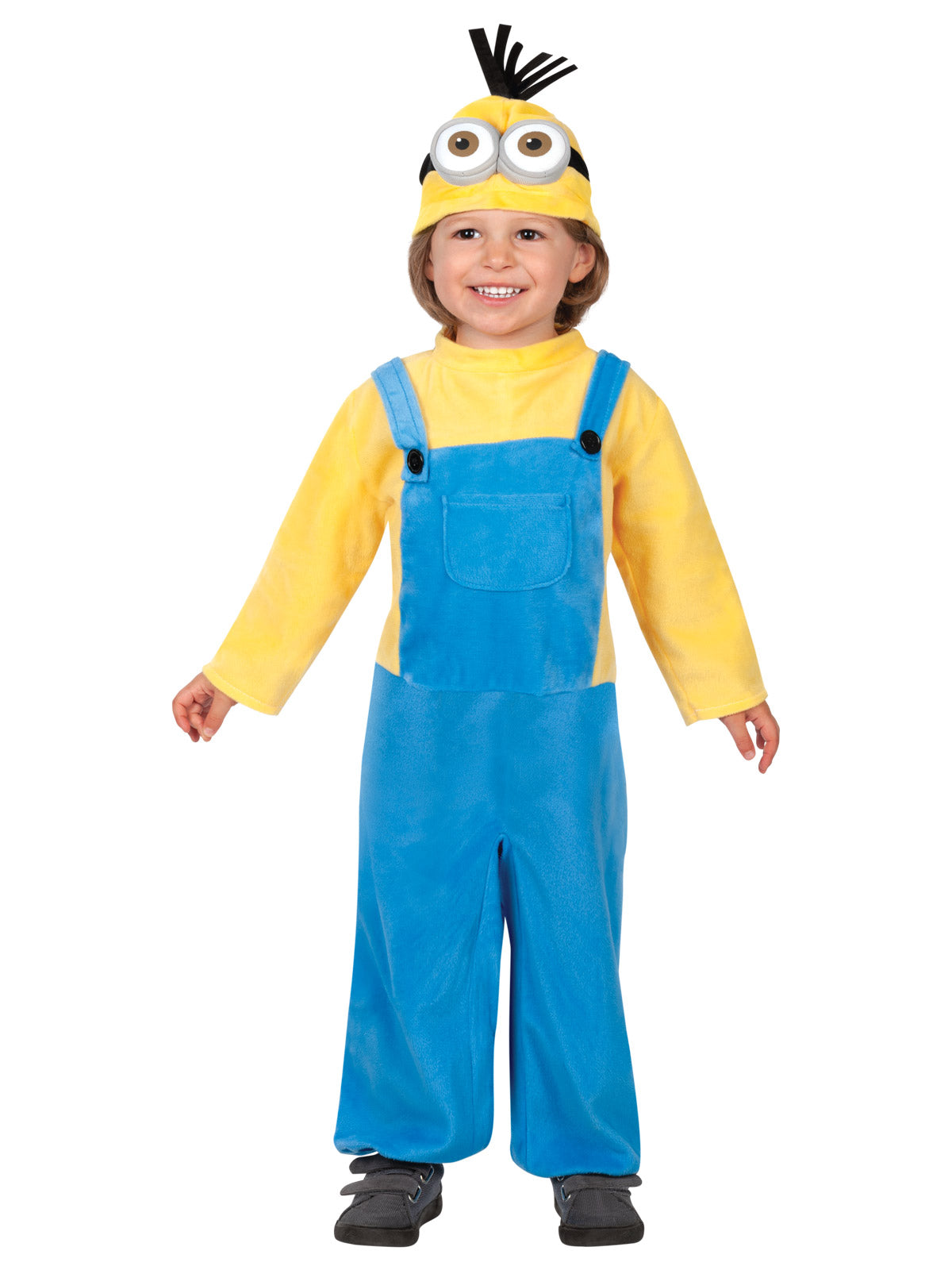 Toddler standing in the Minion Kevin jumpsuit with blue overalls and goggle snood