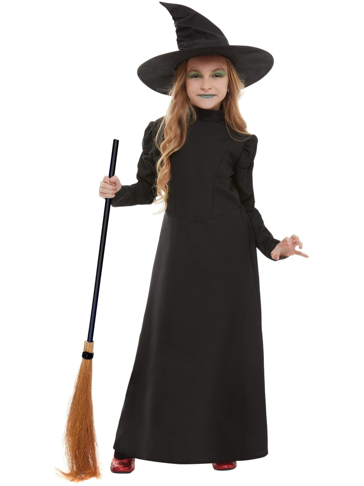 Girl posing in the wicked witch black dress and tall pointed hat