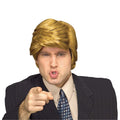 Man in a suit wearing a blonde side-parted wig with a swept fringe