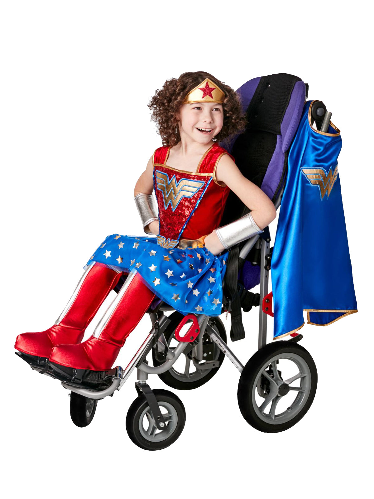 Girl using a wheelchair in an adaptive Wonder Woman dress with star skirt, blue cape, tiara and red boot covers