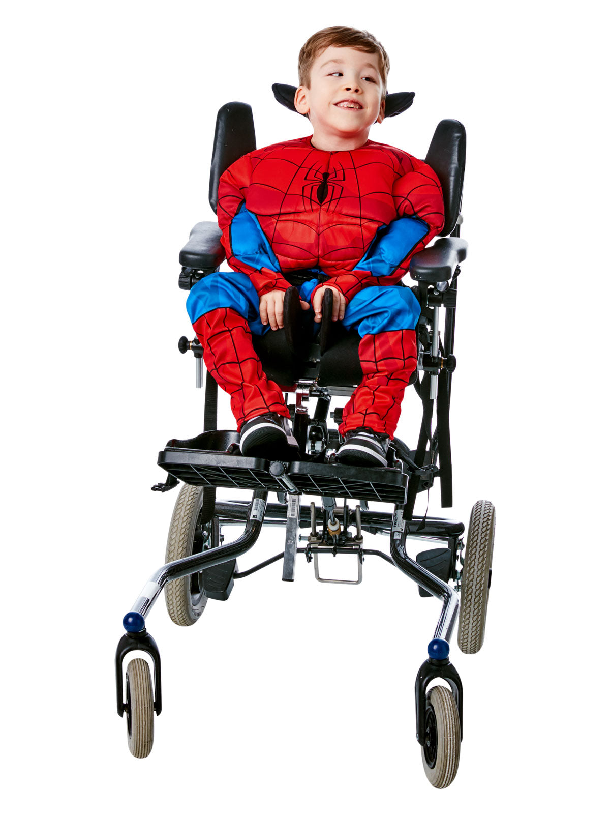Smiling boy using a wheelchair in the adaptive Spider-Man top and pants, mask pushed up