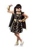 Girl in premium Batgirl tutu dress with sequin bodice, gold bat print skirt, gold belt and black cape