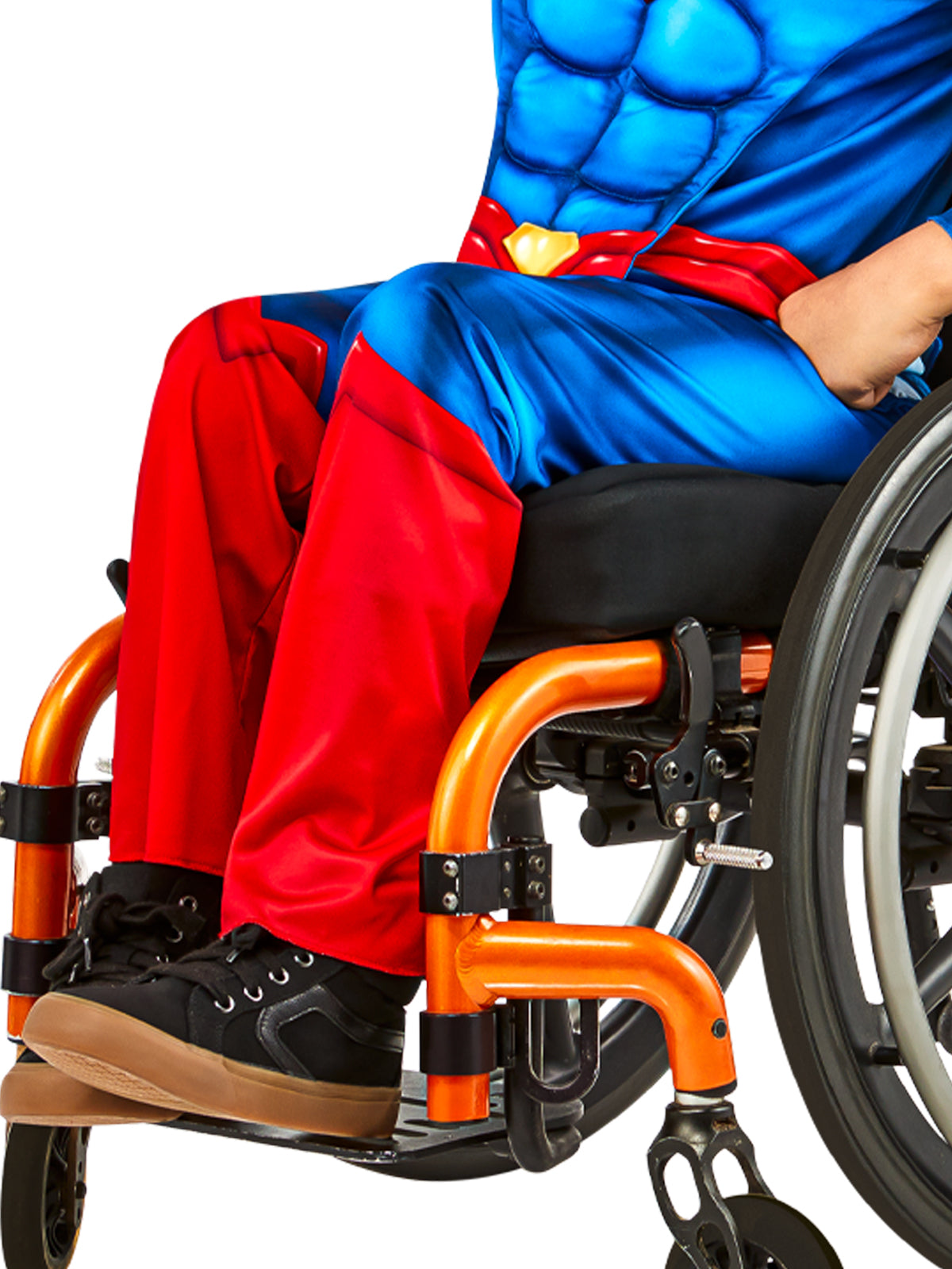 Close-up of the adaptive Superman costume's printed red pants, shown while seated in a wheelchair